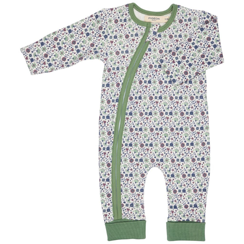 Floral-patterned baby onesie with a green zipper on a white background