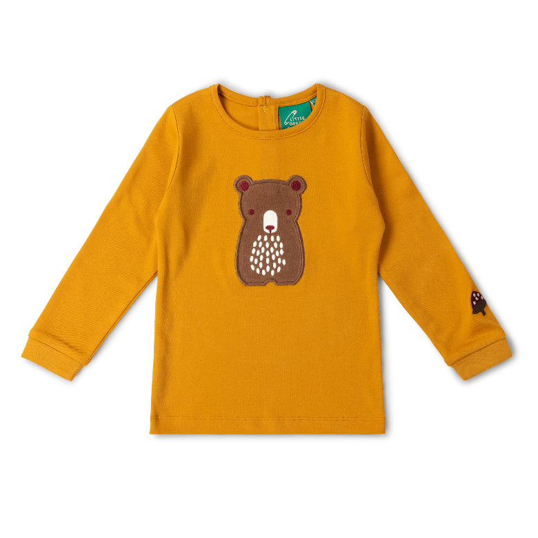 A mustard yellow long-sleeve children's top with a brown bear face applique on the chest and a small bear patch on the right sleeve, shown flat on a white background.