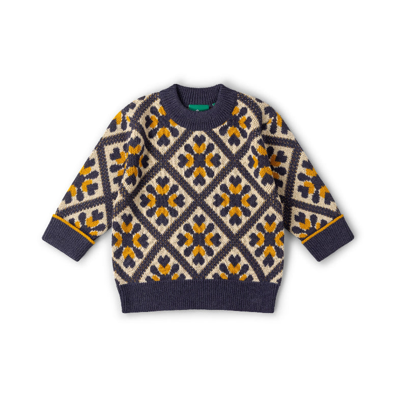 A long-sleeve knit sweater with a geometric diamond pattern in navy blue, cream, and mustard yellow, laid flat on a white background.