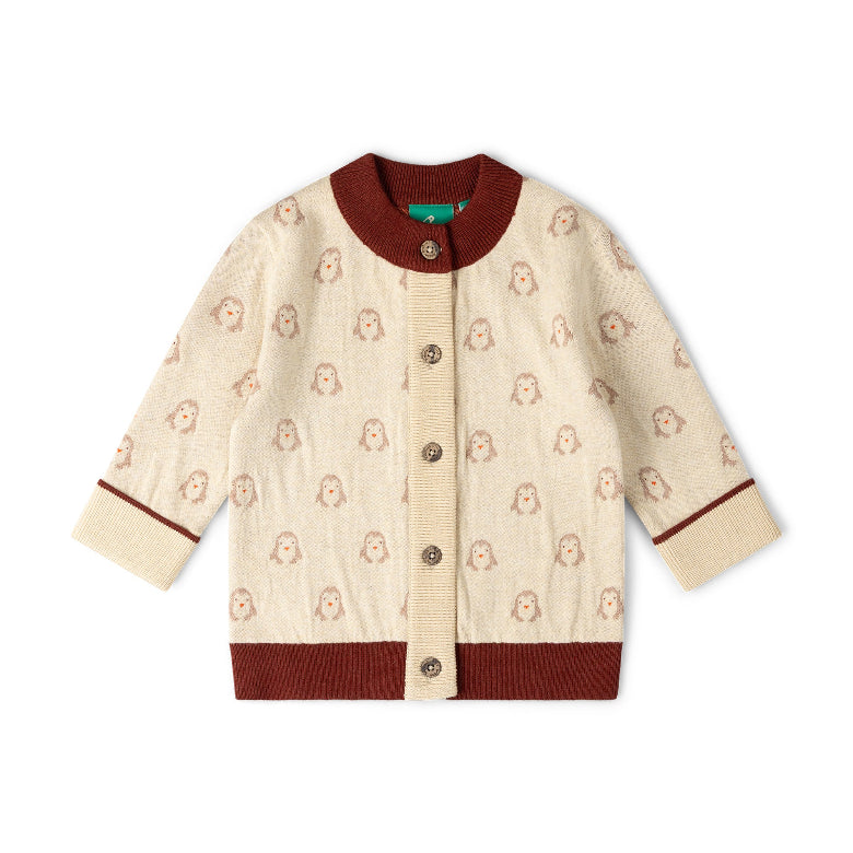 A cream-colored knit cardigan sweater with a repeating pattern of small brown cartoon faces, featuring dark brown ribbed trim on the collar, cuffs, and hem, and a front button closure.