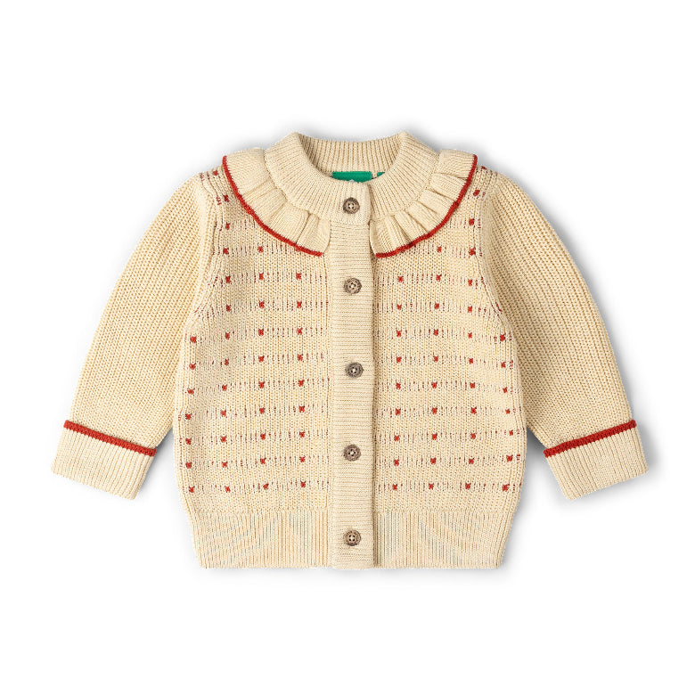 A cream-colored baby knit cardigan sweater with a ruffled Peter Pan collar, button closure, and red trim details on the collar, cuffs, and body pattern, shown on a plain white background.