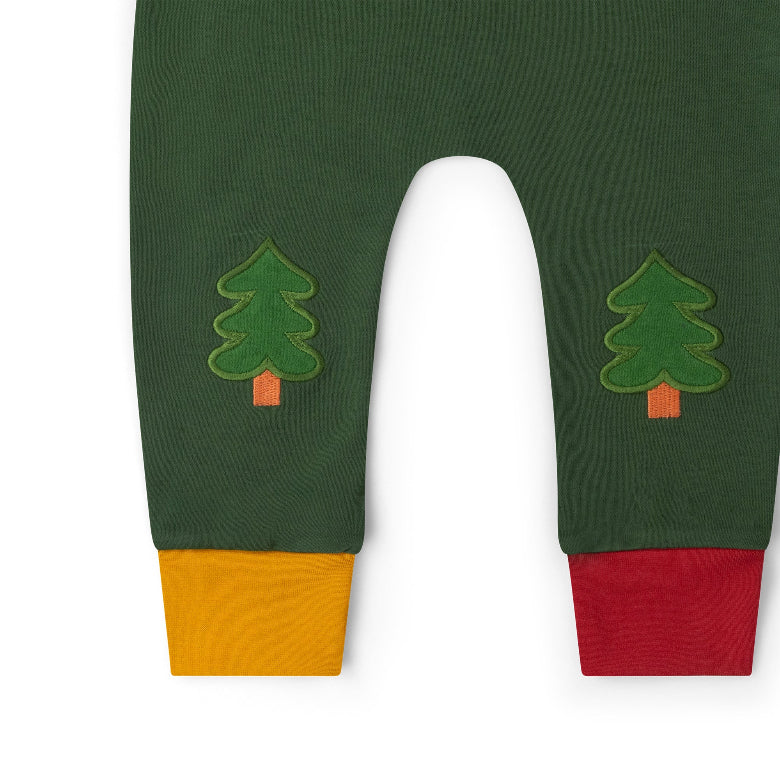 Dark green children's pants with embroidered pine tree motifs on the upper legs and contrasting ribbed cuffs in mustard yellow and red, shown on a white background.