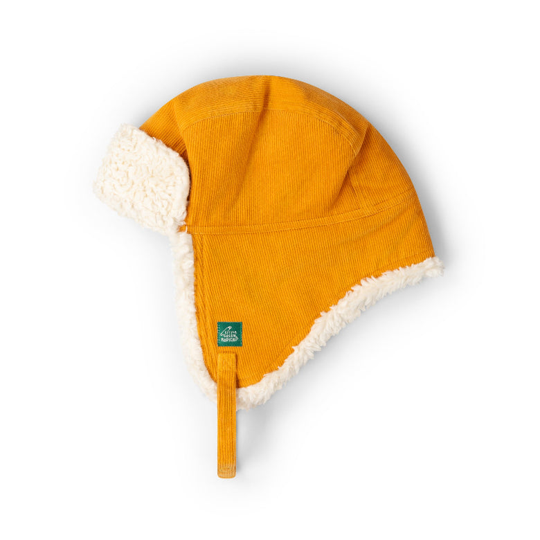 A mustard yellow corduroy aviator-style winter hat with cream sherpa ear flaps and a matching chin strap, shown on a clean white background.