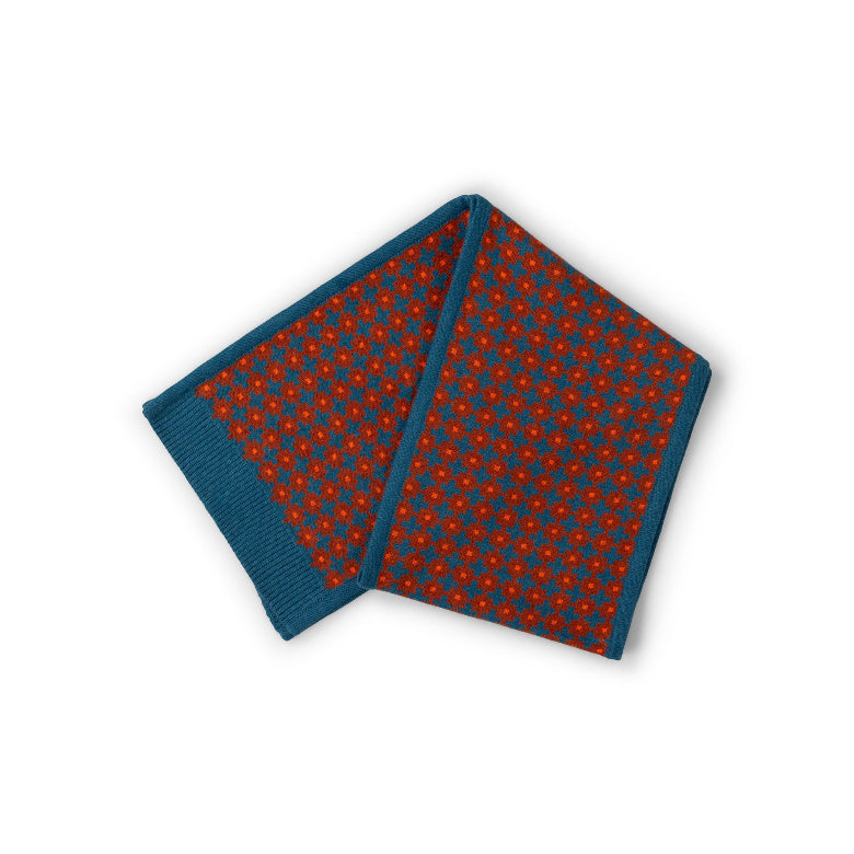 A folded pocket square featuring a red and blue micro-patterned design with a solid blue ribbed border, displayed on a clean white background.