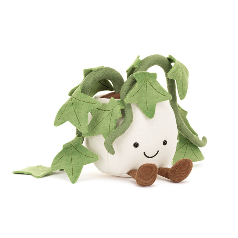 Plush toy shaped like a white eggplant with green leaves on a white background