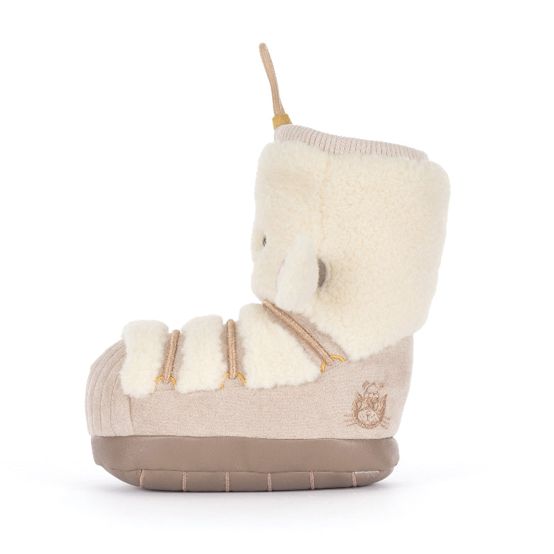 A single baby bootie with a plush cream sheepskin-like collar and toe, a beige suede-like body, and a brown sole, shown from the side on a white background.
