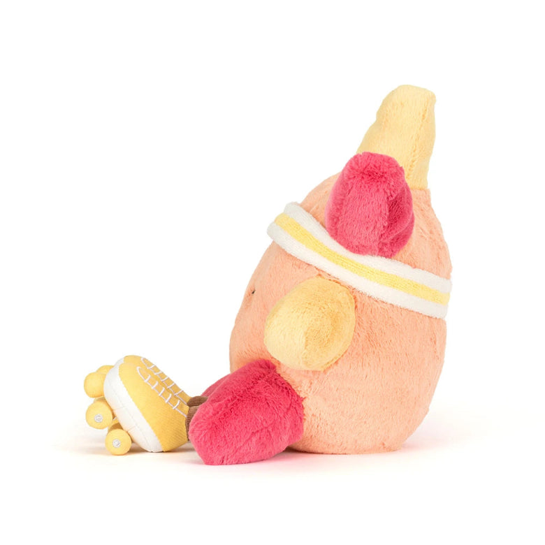 Plush toy resembling a banana with pink ends on a white background