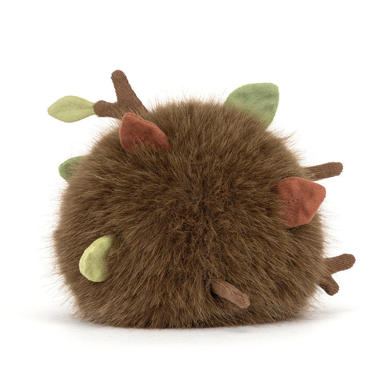 Plush toy resembling a brown creature with green accents on a white background