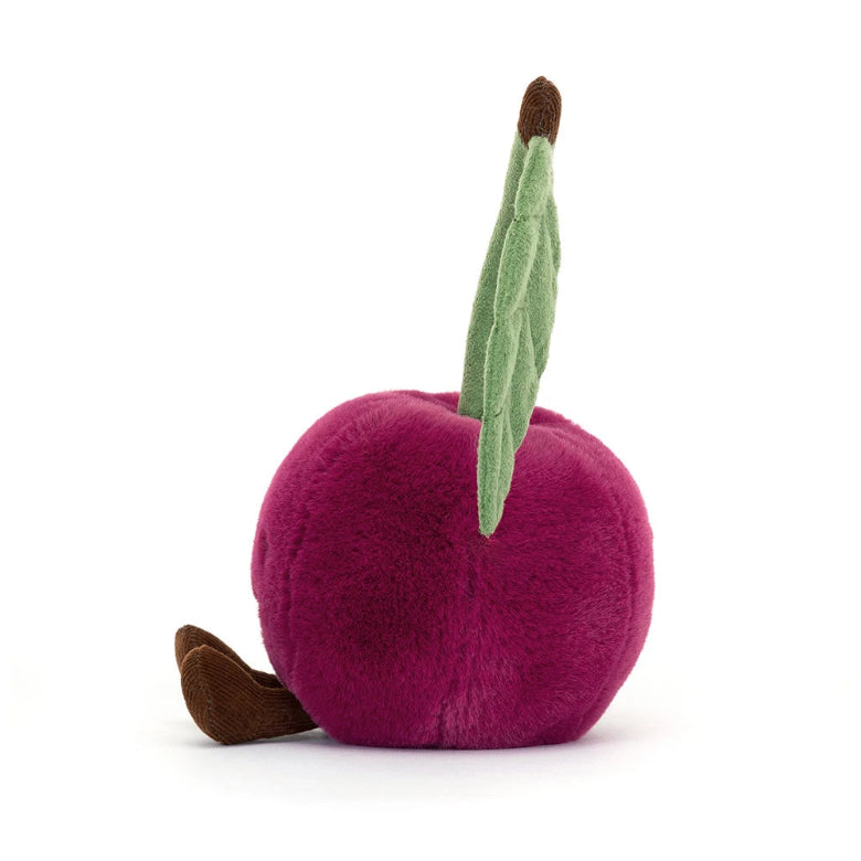 Plush plum toy with a green leaf on a white background