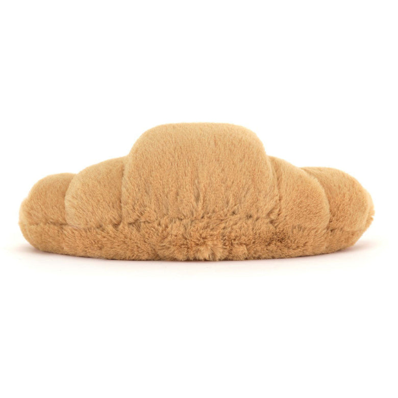 Plush toy shaped like a croissant on a white background