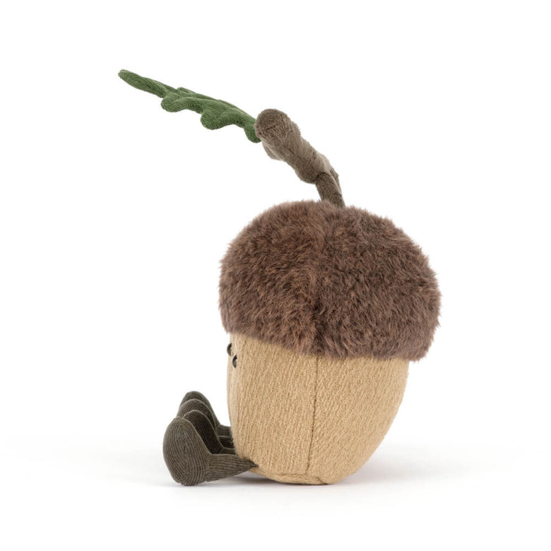 Stuffed toy acorn with a branch on a white background