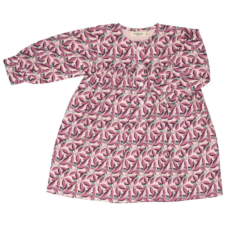 A long-sleeve babydoll dress with a pink and white floral pattern, laid flat on a white background.