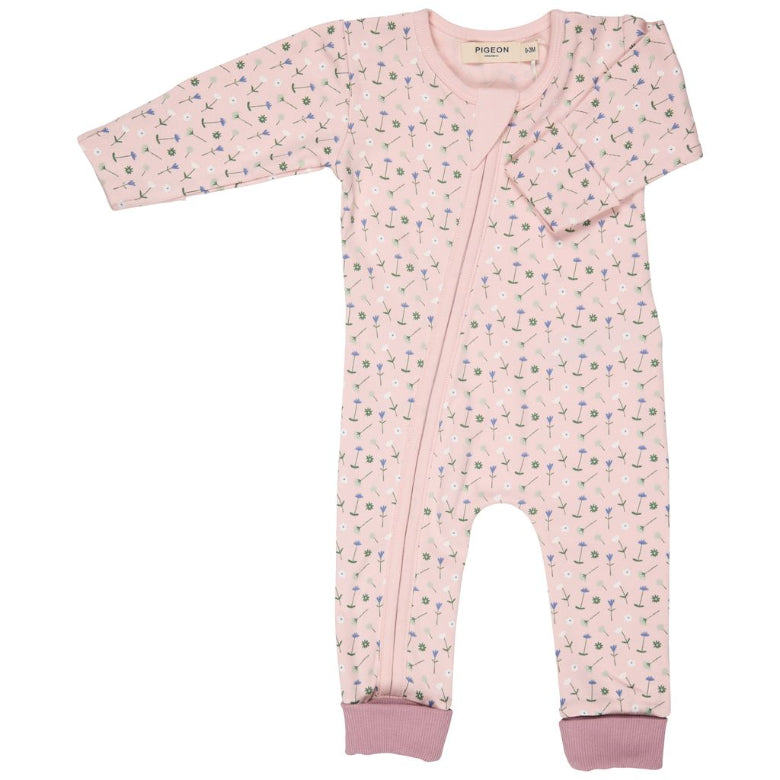 Pink baby onesie with floral pattern on a white background