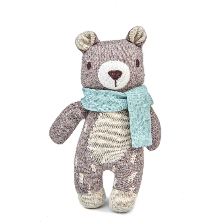 Stuffed bear toy with a light blue scarf on a white background