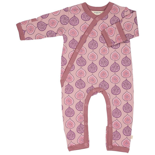 A baby long-sleeve footless one-piece sleeper in dusty pink with an allover purple and pink fig pattern, featuring snap closures down the front and a chest pocket.