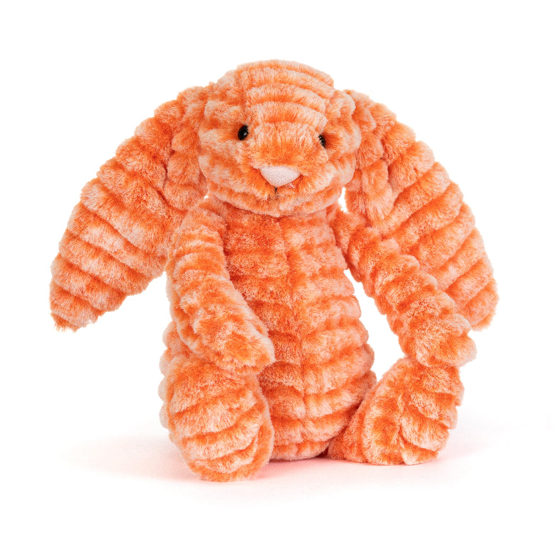 An orange plush bunny toy with a ribbed, corduroy-like texture, sitting against a solid white background.