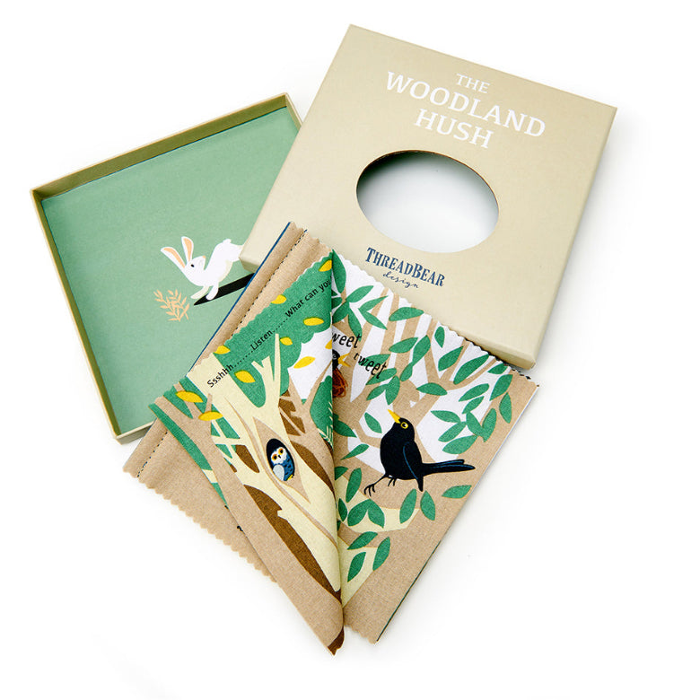 Children's book titled 'The Woodland Hush' by ThreadBear with a green cover and beige spine.