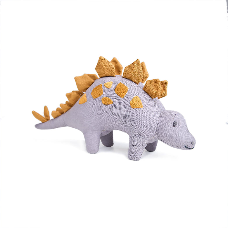Plush toy dinosaur with yellow spikes on a white background