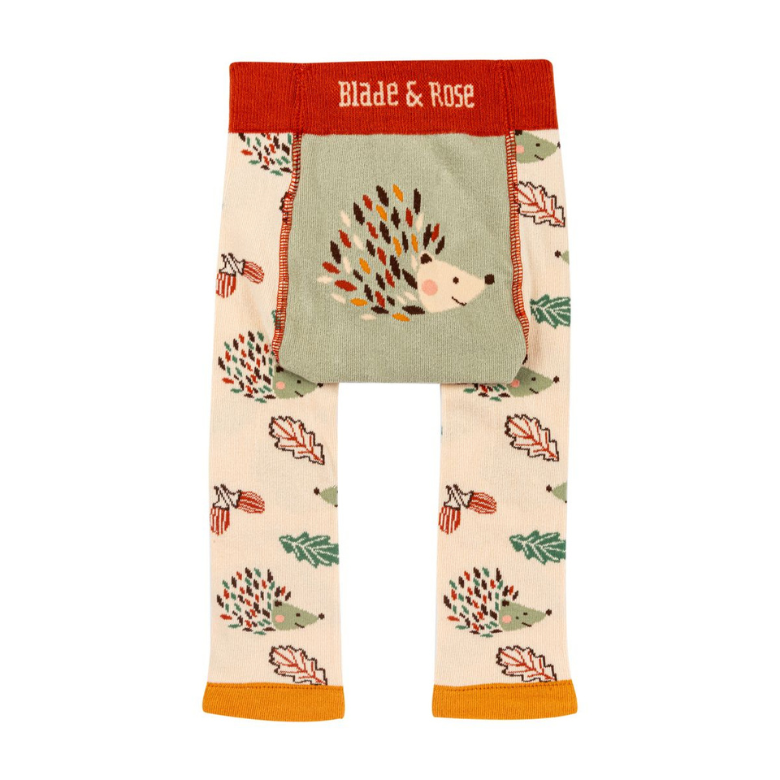Toddler knit pants with a woodland hedgehog and autumn leaf pattern, featuring a sage green front patch pocket and a red waistband with 'Blade & Rose' in white text.