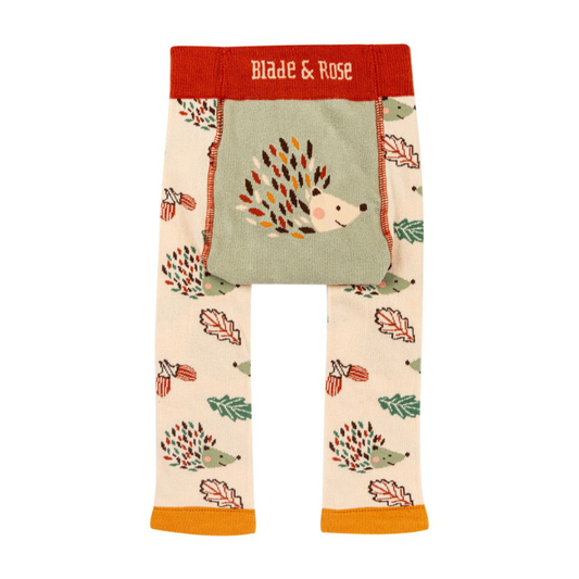 Toddler knit pants with a woodland hedgehog and autumn leaf pattern, featuring a sage green front patch pocket and a red waistband with 'Blade & Rose' in white text.