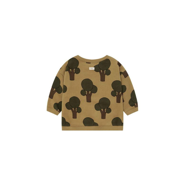 A toddler's long-sleeve crewneck sweatshirt in a warm tan color, featuring an all-over print of dark green tree silhouettes, shown flat against a solid white background.