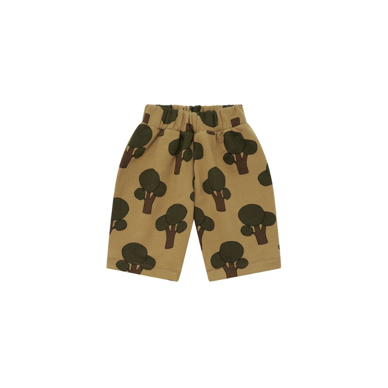 A pair of toddler shorts in a warm tan color, featuring an all-over print of dark green and brown tree silhouettes, shown against a plain white background.