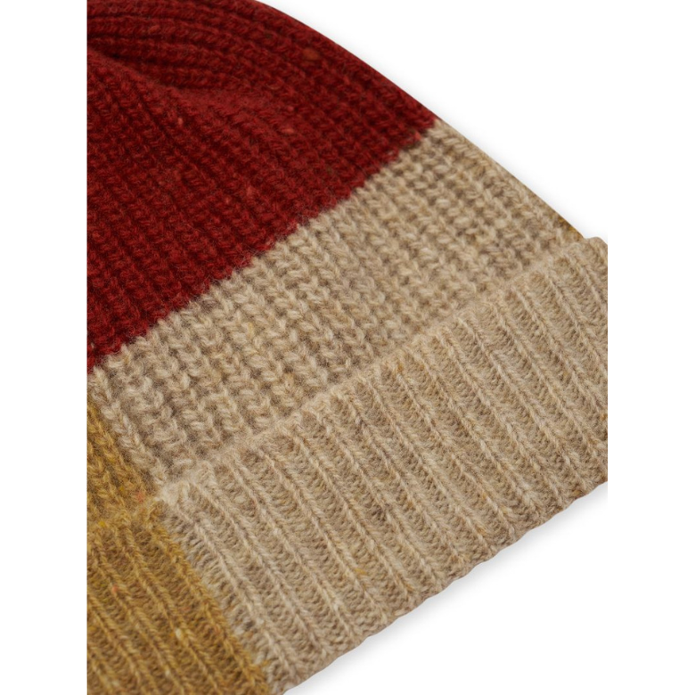 Close-up of a knitted beanie hat showing three color-blocked sections: a deep red knit section at the top, a wide beige/tan section in the middle, and a mustard yellow ribbed cuff at the bottom, set against a plain white background.