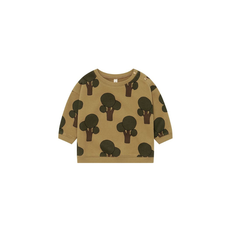 A toddler's long-sleeve crewneck sweatshirt in a warm tan color, featuring an all-over print of dark green and brown tree silhouettes, shown flat on a white background.