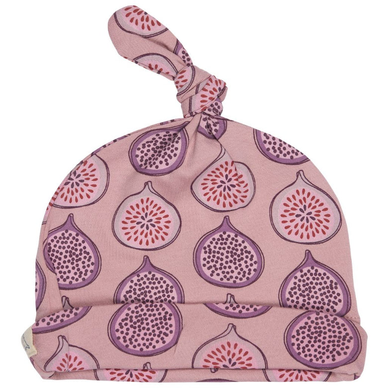 A pink knotted baby hat featuring a repeating pattern of purple and red figs, shown against a plain white background.