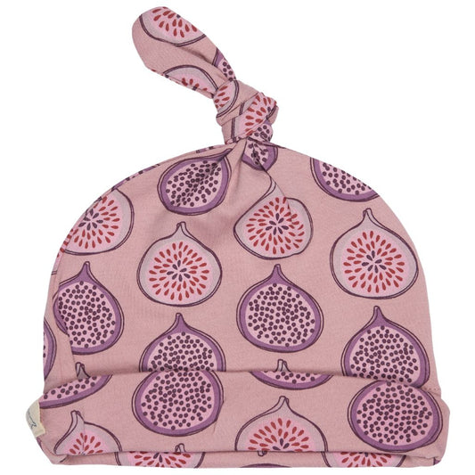 A pink knotted baby hat featuring a repeating pattern of purple and red figs, shown against a plain white background.