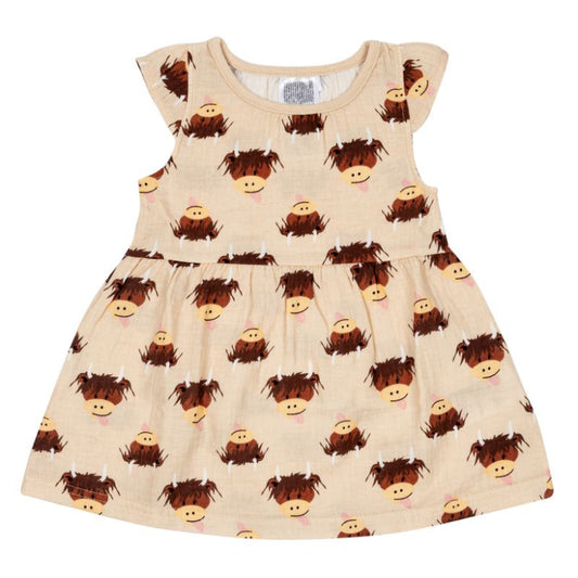 Beige dress with cartoon cow pattern on a white background