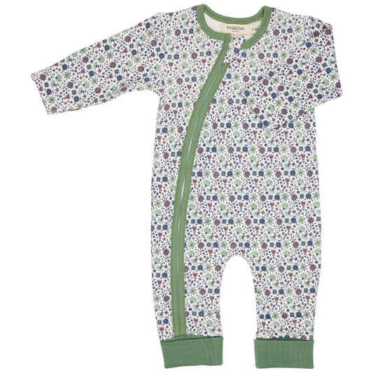 Floral-patterned baby onesie with a green zipper on a white background