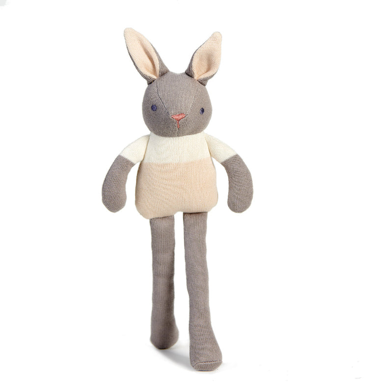 Knitted toy rabbit with a plain background