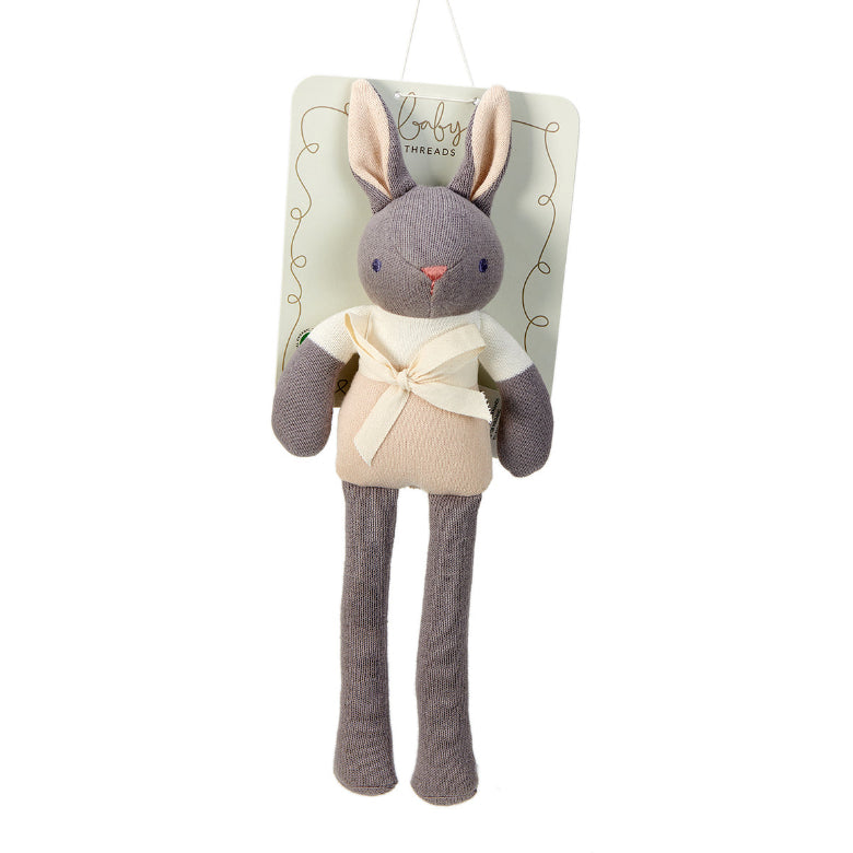 Stuffed rabbit toy with a beige bow tie on a white background