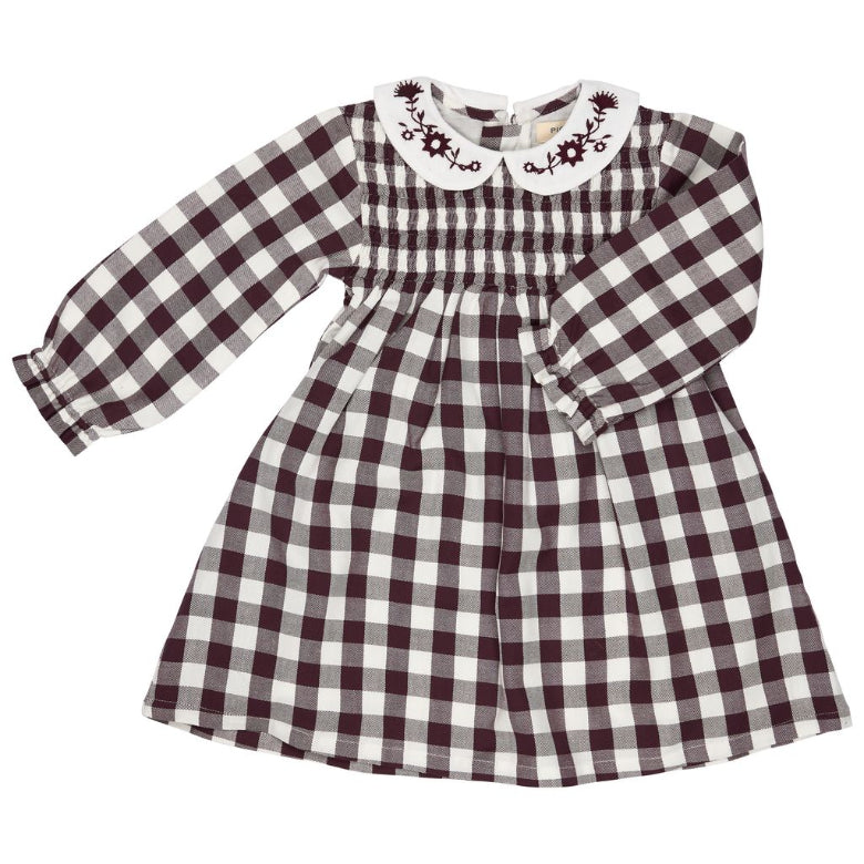 A long-sleeve baby dress with a dark brown and white gingham check pattern, featuring a smocked bodice and a white Peter Pan collar with dark brown floral embroidery.