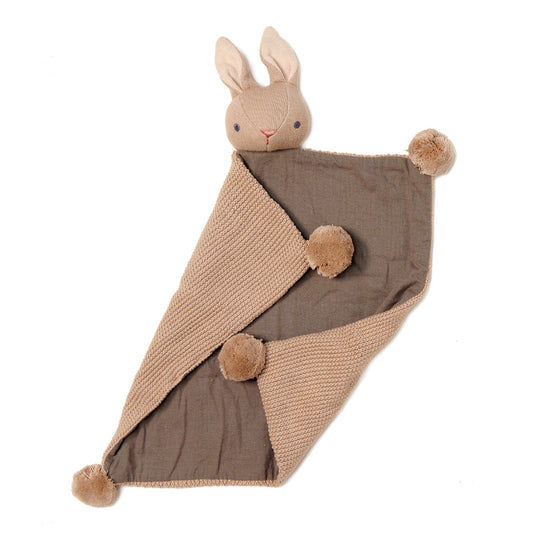 Knitted blanket with a plush bunny toy on a white background