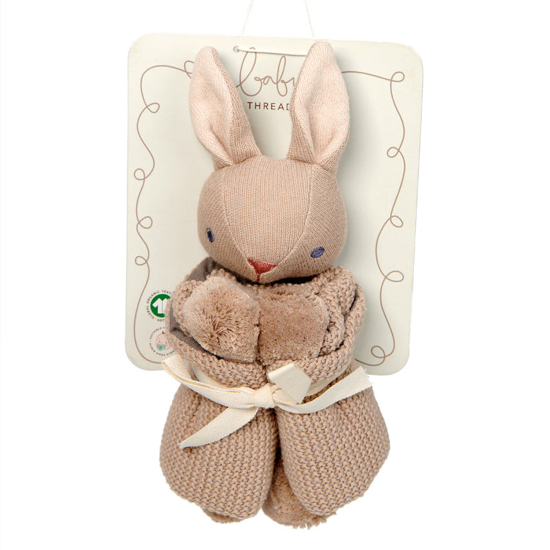 Plush rabbit toy with a bow on a white background