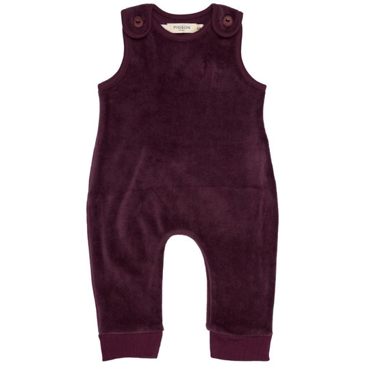 A dark plum corduroy baby romper with shoulder buttons, photographed flat against a solid white background.