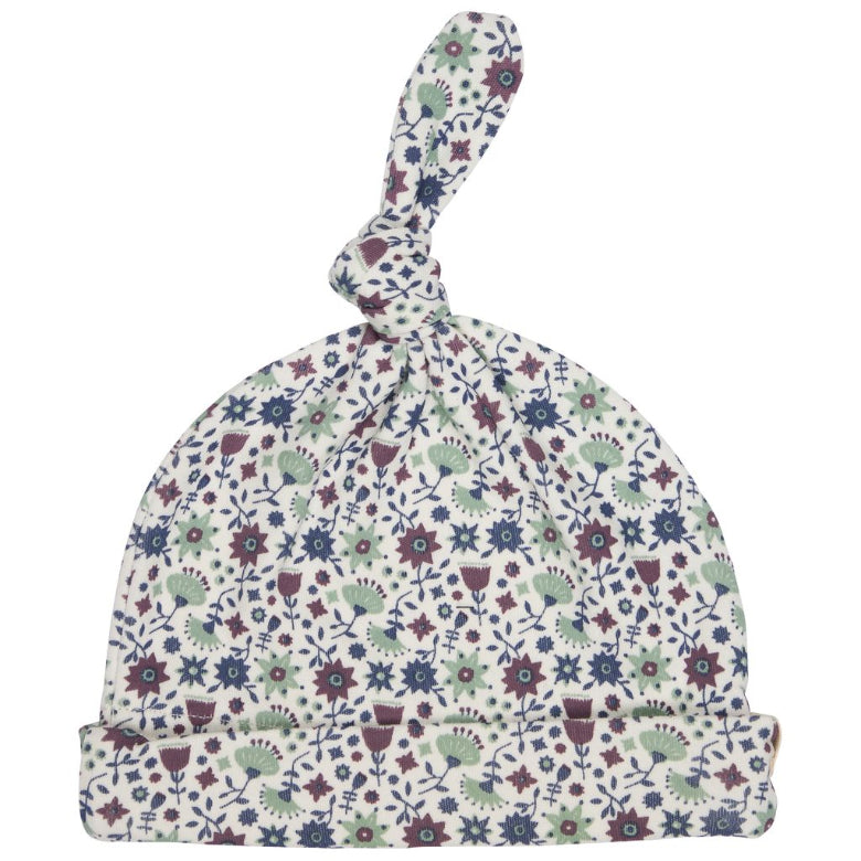 A baby knit hat with a knotted top and a folded brim, featuring an all-over delicate floral and botanical print in muted blue, sage green, burgundy, and cream on a white background.