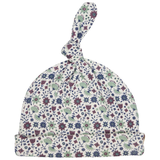 A baby knit hat with a knotted top and a folded brim, featuring an all-over delicate floral and botanical print in muted blue, sage green, burgundy, and cream on a white background.